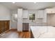 Bright kitchen with stainless steel appliances and white cabinets, seamlessly connected to the dining area at 8025 Cliffside Dr, Charlotte, NC 28270