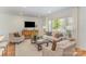 Bright and open living room with large window, comfortable seating, and modern decor at 8025 Cliffside Dr, Charlotte, NC 28270