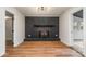 Bright living room with sleek hardwood floors and a striking black painted brick fireplace at 8025 Cliffside Dr, Charlotte, NC 28270