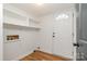 Mud room with ample shelving and a conveniently placed door and sleek flooring at 8025 Cliffside Dr, Charlotte, NC 28270
