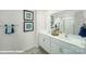 Bathroom featuring double sink vanity, framed mirrors, modern fixtures, and tiled flooring and shower at 818 N Naughton St, Chester, SC 29706