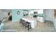 Island with barstool seating in kitchen with white cabinetry, stainless appliances, and granite countertops at 818 N Naughton St, Chester, SC 29706
