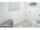 Laundry room with gray tile flooring, wire shelving, and laundry supply decor at 818 N Naughton St, Chester, SC 29706