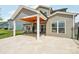 Covered backyard patio with outdoor seating and tiled flooring at 8715 Gladden Hill Ln, Fort Mill, SC 29715