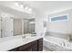 Bathroom featuring a soaking tub, a stand-up shower, and a modern double vanity at 8715 Gladden Hill Ln, Fort Mill, SC 29715