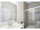 Modern bathroom with glass shower, vanity with mirror and sink, and neutral-toned tile at 8715 Gladden Hill Ln, Fort Mill, SC 29715