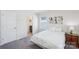 Cozy bedroom with a queen bed, floral artwork, and a window with natural light at 8715 Gladden Hill Ln, Fort Mill, SC 29715