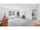 Spacious bonus room with plush carpeting, natural light, and a cozy seating area at 8715 Gladden Hill Ln, Fort Mill, SC 29715