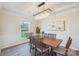 Charming dining room features a decorative chandelier, wooden table and chairs, and a large window at 8715 Gladden Hill Ln, Fort Mill, SC 29715