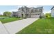 Charming two-story home with well-manicured lawn and a two-car garage at 8715 Gladden Hill Ln, Fort Mill, SC 29715