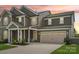 Charming two-story home with a well-manicured lawn, a two-car garage, and a welcoming front porch at 8715 Gladden Hill Ln, Fort Mill, SC 29715
