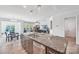 Open-concept kitchen with an island, stainless steel appliances, and a view into the living room at 8715 Gladden Hill Ln, Fort Mill, SC 29715