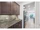 Modern kitchen with granite countertops, stainless steel appliances, view of dining room and natural light at 8715 Gladden Hill Ln, Fort Mill, SC 29715