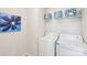 Well-lit laundry room with a washer, dryer, shelving and decor at 8715 Gladden Hill Ln, Fort Mill, SC 29715