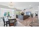 Inviting living room with a stone fireplace and views into the dining area at 8715 Gladden Hill Ln, Fort Mill, SC 29715