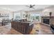 Spacious living room with a stone fireplace, large windows, and an open floor plan at 8715 Gladden Hill Ln, Fort Mill, SC 29715