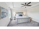 This main bedroom boasts a tray ceiling, neutral decor, and lots of natural light at 8715 Gladden Hill Ln, Fort Mill, SC 29715