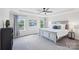 This main bedroom features a tray ceiling, neutral decor, and lots of natural light at 8715 Gladden Hill Ln, Fort Mill, SC 29715