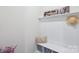 Organized mudroom area featuring storage shelves, a bench, and decorative accents at 8715 Gladden Hill Ln, Fort Mill, SC 29715