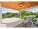 Covered patio with tongue and groove wood ceiling, ceiling fan, and outdoor seating at 8715 Gladden Hill Ln, Fort Mill, SC 29715