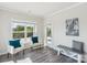 Cozy sitting area with natural light, white chairs with blue pillows and outdoor views at 8715 Gladden Hill Ln, Fort Mill, SC 29715