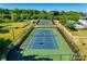 Beautifully maintained tennis courts surrounded by lush greenery in a quiet community setting at 8715 Gladden Hill Ln, Fort Mill, SC 29715