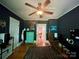 Bedroom with a ceiling fan, hardwood floors, and adjacent door leading to the hallway at 1000 Margaret Brown St, Charlotte, NC 28202