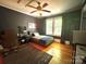 Comfortable bedroom with hardwood floors, ceiling fan, neutral wall color, and natural light at 1000 Margaret Brown St, Charlotte, NC 28202