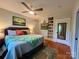Cozy bedroom with a bed, ceiling fan, built-in shelving, and lots of natural light at 1000 Margaret Brown St, Charlotte, NC 28202