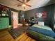 Bedroom featuring hardwood floors, ceiling fan, neutral walls, and bed with desk and chair at 1000 Margaret Brown St, Charlotte, NC 28202