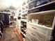 Organized closet with custom shelving and drawers, offering ample storage space for shoes and clothing at 1000 Margaret Brown St, Charlotte, NC 28202