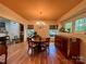 Elegant dining room featuring hardwood floors, a chandelier, and large windows providing natural light at 1000 Margaret Brown St, Charlotte, NC 28202