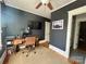 Inviting home office with dark gray walls, modern desk, and a comfortable chair for a productive workspace at 1000 Margaret Brown St, Charlotte, NC 28202