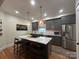 Stylish kitchen featuring gray cabinetry, stainless steel appliances, marble island, and pendant lighting at 1000 Margaret Brown St, Charlotte, NC 28202