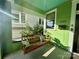 Relaxing porch swing with decorative pillows on a covered porch, perfect for enjoying the outdoors at 1000 Margaret Brown St, Charlotte, NC 28202
