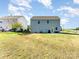 Large backyard with healthy, green grass and two-story home at 101 Glencroft Dr, Wingate, NC 28174