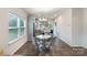 Bright dining area with a marble table and chairs, adjacent to a kitchen at 101 Glencroft Dr, Wingate, NC 28174