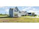 A well-manicured lawn surrounds this two-story home with gray siding and an attached garage at 101 Glencroft Dr, Wingate, NC 28174