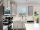 Well-lit kitchen featuring stainless steel appliances and granite countertops at 101 Glencroft Dr, Wingate, NC 28174