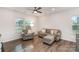 Relaxing living room setup with a plush sofa, ottoman, and ceiling fan at 101 Glencroft Dr, Wingate, NC 28174