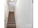 Carpeted staircase with white risers leads to the upper level at 101 Glencroft Dr, Wingate, NC 28174