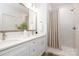 Bright bathroom featuring double vanity, sleek shower with stylish curtain and marble tiles at 1032 Dooley Dr, Charlotte, NC 28227