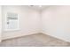 Carpeted bedroom with a large window offering plenty of natural light at 1032 Dooley Dr, Charlotte, NC 28227