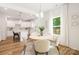 Charming dining area with a round table, modern lighting, and a view into the kitchen at 1032 Dooley Dr, Charlotte, NC 28227