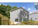 Rear exterior of home showcasing backyard, gray siding and wood fence at 1032 Dooley Dr, Charlotte, NC 28227