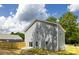 Rear exterior showcasing the new home with backyard and blue skies at 1032 Dooley Dr, Charlotte, NC 28227