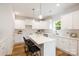 Modern kitchen with white cabinets, stainless steel appliances, quartz countertops, and an island with seating at 1032 Dooley Dr, Charlotte, NC 28227