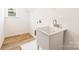Functional laundry room with sink, laminate flooring, and natural light at 1032 Dooley Dr, Charlotte, NC 28227