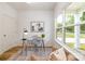 Bright office space with large window, glass top desk, and neutral decor at 1032 Dooley Dr, Charlotte, NC 28227