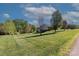 A spacious, grassy backyard with scattered trees and a partial view of the house at 106 Zurich Ln, Statesville, NC 28625